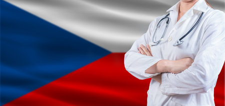 Doctor with crossed arms on Czech Republic flag. Czech Republic health and care concept. Female doctor on Czech Republic flagの写真素材