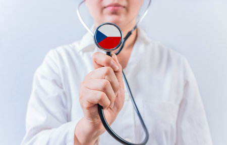 Female doctor holding stethoscope with Czech Republic flag. National health system of Czech Republicの写真素材