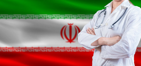 Doctor with crossed arms on Iran flag. Iranian health and care concept. Female doctor on Iran flagの写真素材