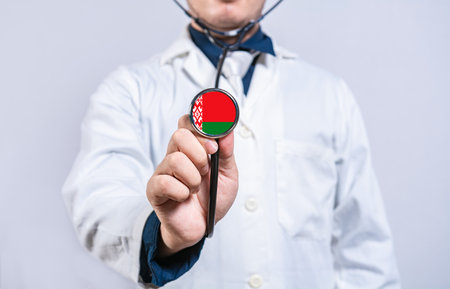 Doctor hands holding stethoscope with Belarus flag. Belarus health and care conceptの写真素材