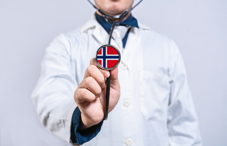 Doctor hands holding stethoscope with Norway flag. Norway health and care conceptの写真素材