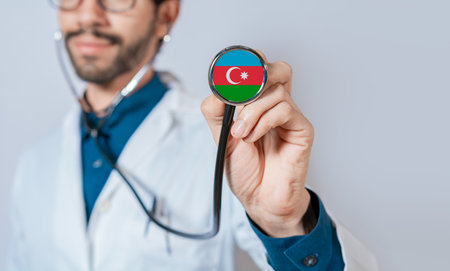 Doctor holding stethoscope with Azerbaijan flag. Azerbaijan health and care concept, Azerbaijan flag on stethoscopeの写真素材