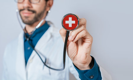 Doctor holding stethoscope with Switzerland flag. Switzerland health and care concept, Switzerland flag on stethoscopeの写真素材