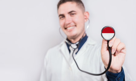 Doctor showing stethoscope with flag. National healthcare conceptの写真素材