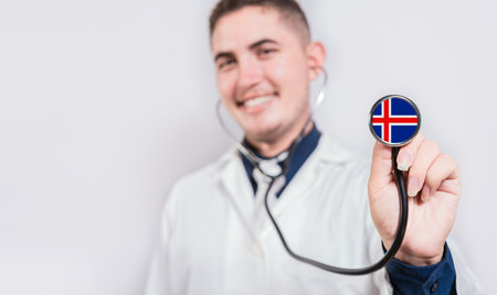 Doctor showing stethoscope with Iceland flag. Iceland national healthcare conceptの写真素材