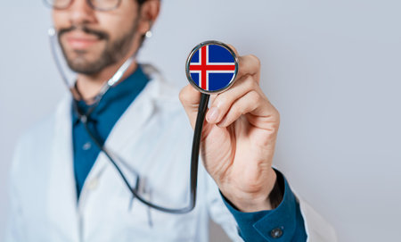Doctor holding stethoscope with Iceland flag. Iceland health and care concept, Iceland flag on stethoscopeの写真素材