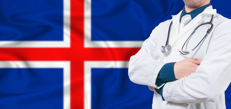 Iceland healthcare concept. Male doctor on Iceland flag. Doctor with crossed arms on Iceland flagの写真素材