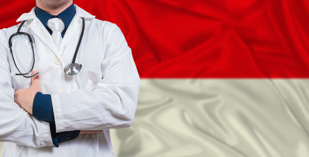 Male doctor with stethoscope on Indonesia flag. Doctor holding stethoscope on Indonesia flagの写真素材