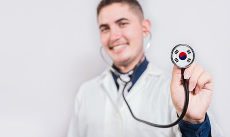 Doctor showing stethoscope with South Korea flag. South Korea national healthcare conceptの写真素材