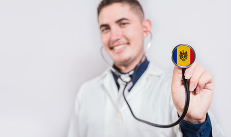 Doctor showing stethoscope with Moldova flag. Moldova national healthcare conceptの写真素材