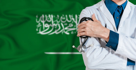 Doctor with stethoscope on Saudi Arabia flag. Doctor holding stethoscope on Saudi Arabia flagの写真素材