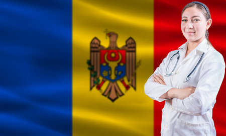 Female doctor on Moldova flag. Doctor with crossed arms on Moldova flag. Moldova health and care conceptの写真素材