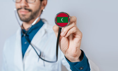 Doctor holding stethoscope with Maldives flag. Maldives health and care concept, Maldives flag on stethoscopeの写真素材