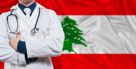 Male doctor with stethoscope on Lebanese flag. Doctor holding stethoscope on Lebanon flagの写真素材