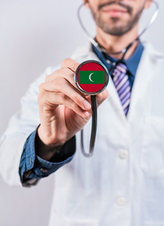 Maldives health and medical insurance concept. Maldives healthcare system, doctor holding stethoscopeの写真素材
