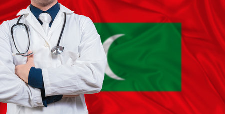 Male doctor with stethoscope on Maldivian flag. Doctor holding stethoscope on Maldives flagの写真素材