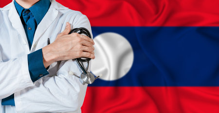 Doctor with stethoscope on Laos flag. Doctor holding stethoscope on Laos flagの写真素材