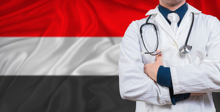 Male doctor with stethoscope on Yemeni flag. Doctor holding stethoscope on Yemen flagの写真素材