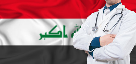 Iraq healthcare concept. Male doctor on Iraq flag. Doctor with crossed arms on Iraq flagの写真素材