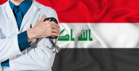 Doctor with stethoscope on Iraq flag. Doctor holding stethoscope on Iraq flagの写真素材