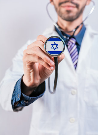 Israel healthcare system, doctor holding stethoscope. Israel health and medical insurance conceptの写真素材