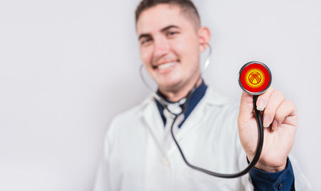 Doctor showing stethoscope with Kyrgyzstan flag. Kyrgyzstan national healthcare conceptの写真素材