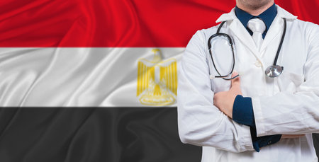 Male doctor with stethoscope on Egypt flag. Doctor holding stethoscope on Egypt flagの写真素材