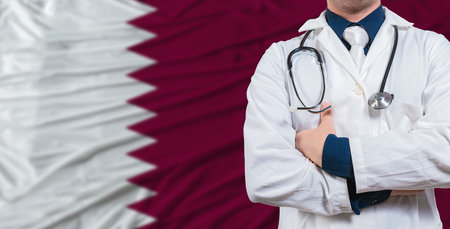 Male doctor with stethoscope on Qatar flag. Doctor holding stethoscope on Qatar flagの写真素材