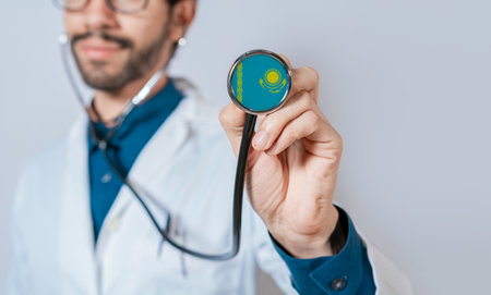 Doctor holding stethoscope with Kazakhstan flag. Kazakhstan health and care concept. Kazakhstan flag on stethoscopeの写真素材