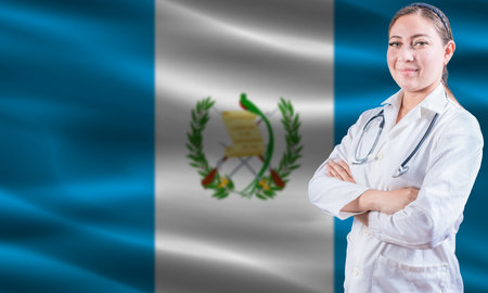 Female doctor on Guatemala flag. Doctor with crossed arms on Guatemala flag. Guatemala health and care conceptの写真素材