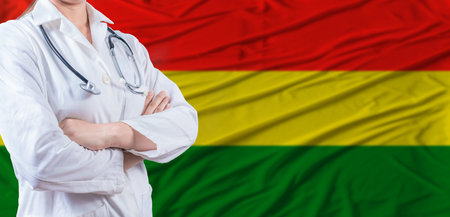 Doctor with crossed arms on Bolivia flag. Bolivia health and care concept. Female doctor on Bolivia flagの写真素材