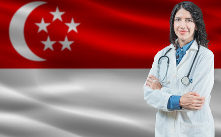 Singaporean medicine and healthcare concept. Close up of doctor against Singapore flag backgroundの写真素材