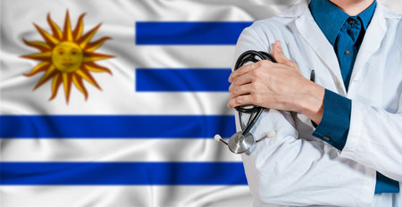 Uruguay healthcare concept. Doctor with stethoscope on Uruguay flag. Doctor holding stethoscope on Uruguayan flagの写真素材