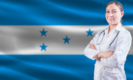 Female doctor on Honduras flag. Doctor with crossed arms on Honduras flag. Honduran health and care conceptの写真素材