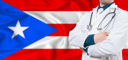 Puerto Rico healthcare concept. Male doctor on Puerto Rico flag. Doctor with crossed arms on Puerto Rico flagの写真素材