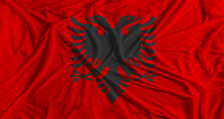 Albanian flag with fabric texture background. National flag of Albania with cloth textureの写真素材
