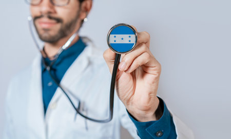 Doctor holding stethoscope with Honduras flag. Honduras health and care concept. Honduras flag on stethoscopeの写真素材