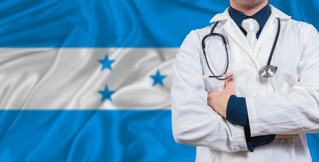 Male doctor with stethoscope on Honduras flag. Doctor holding stethoscope on Honduras flagの写真素材