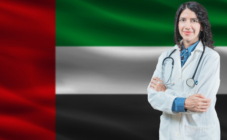 Emirati medicine and healthcare concept. Close up of doctor against United Arab Emirates flag backgroundの写真素材