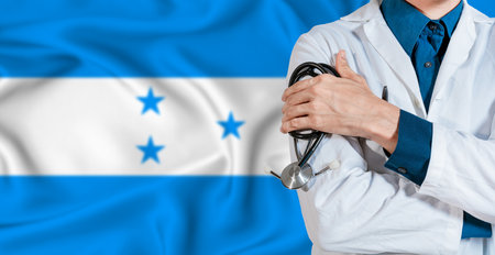 Honduras healthcare concept. Doctor with stethoscope on Honduras flag. Doctor holding stethoscope on Honduran flagの写真素材