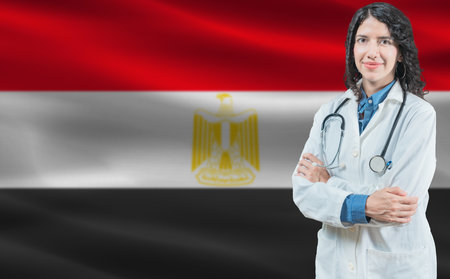 Egyptian medicine and healthcare concept. Close up of doctor against Egypt flag backgroundの写真素材