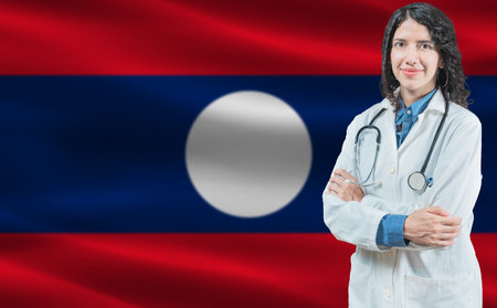 Laotian medicine and healthcare concept Doctor close up against Laos flag backgroundの写真素材