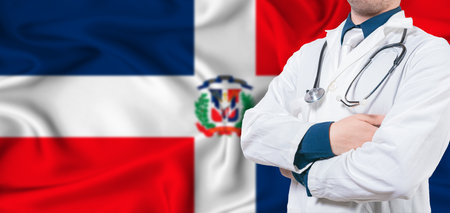 Dominican Republic healthcare concept. Male doctor on Dominican Republic flag. Doctor with crossed arms on Dominican Republic flagの写真素材
