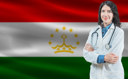 Tajikistani medicine and healthcare concept. Doctor close up against Tajikistan flag backgroundの写真素材