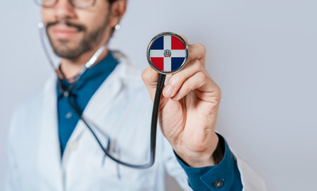 Doctor holding stethoscope with Dominican Republic flag. Dominican Republic health and care concept. Dominican Republic flag on stethoscopeの写真素材