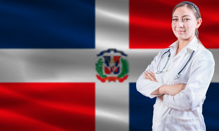 Female doctor on Dominican Republic flag. Doctor with crossed arms on Dominican Republic flag. Dominican Republic health and care conceptの写真素材