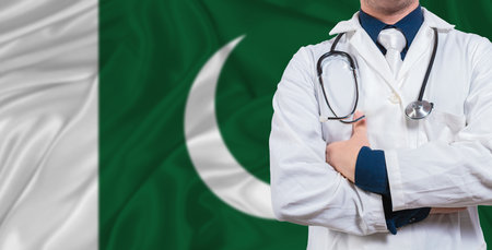 Male doctor with stethoscope on Pakistan flag. Doctor holding stethoscope on Pakistan flagの写真素材