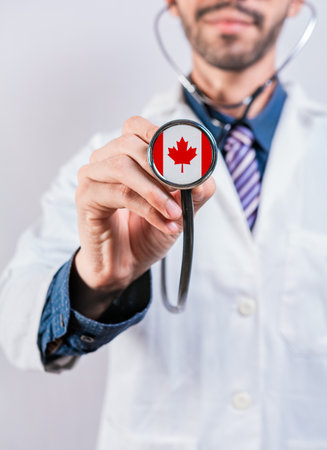 Canada health and medical insurance concept. Canadian Healthcare System, doctor holding stethoscopeの写真素材
