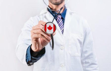 Canada Healthcare System, doctor holding stethoscope. Canada health and medical insurance conceptの写真素材