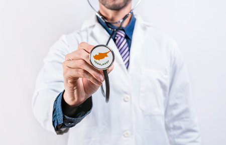Cyprus healthcare system, doctor holding stethoscope. Cyprus health and medical insurance conceptの写真素材
